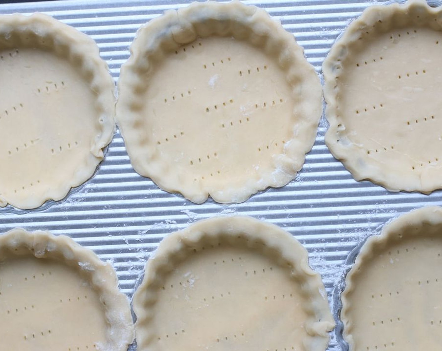 step 6 In a small bowl, beat Egg (1) and Milk (1 Tbsp) with a fork until frothy. Using a pastry brush, lightly brush the edge of each tart crust with the egg wash.  Poke bottom and sides of each tart shell with a fork.