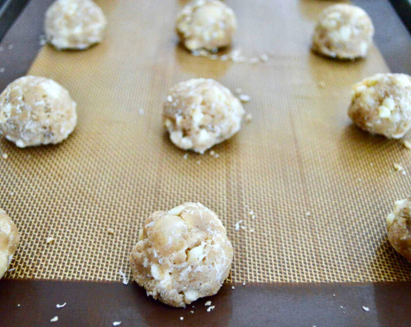 step 8 Scoop the dough into small mounds and roll them into balls the size of your palm. Line them up on the sheet trays, leaving some room to let them spread.