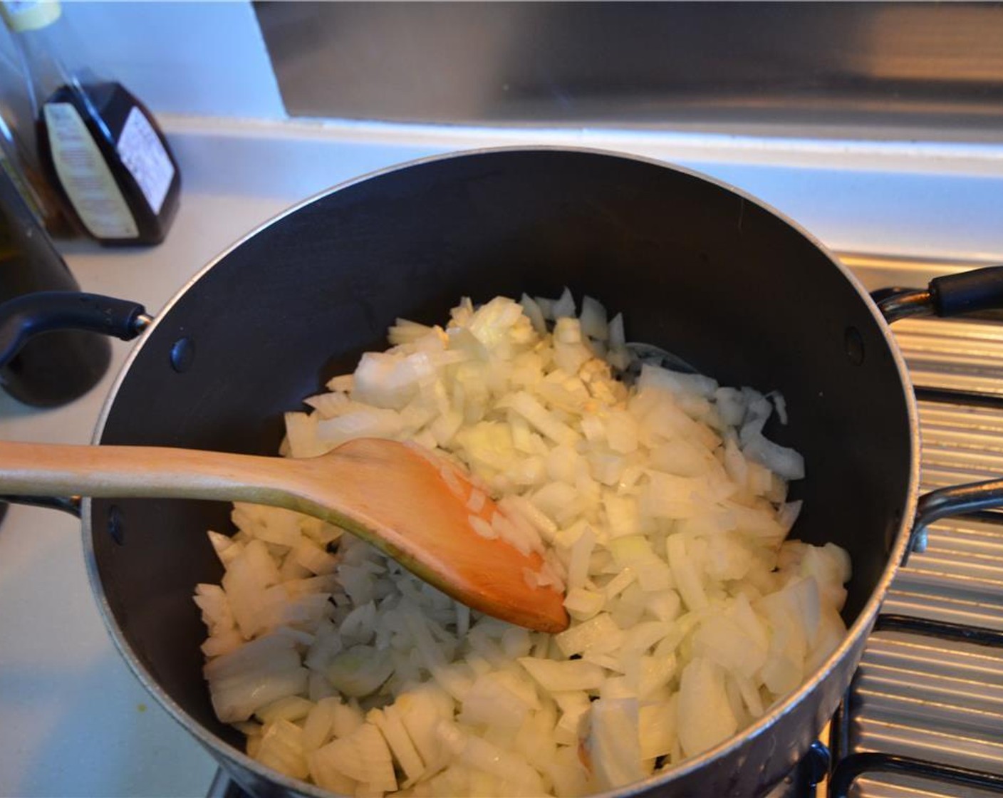step 4 In a large pot, saute the onions and garlic clove for 3 minutes until soft.