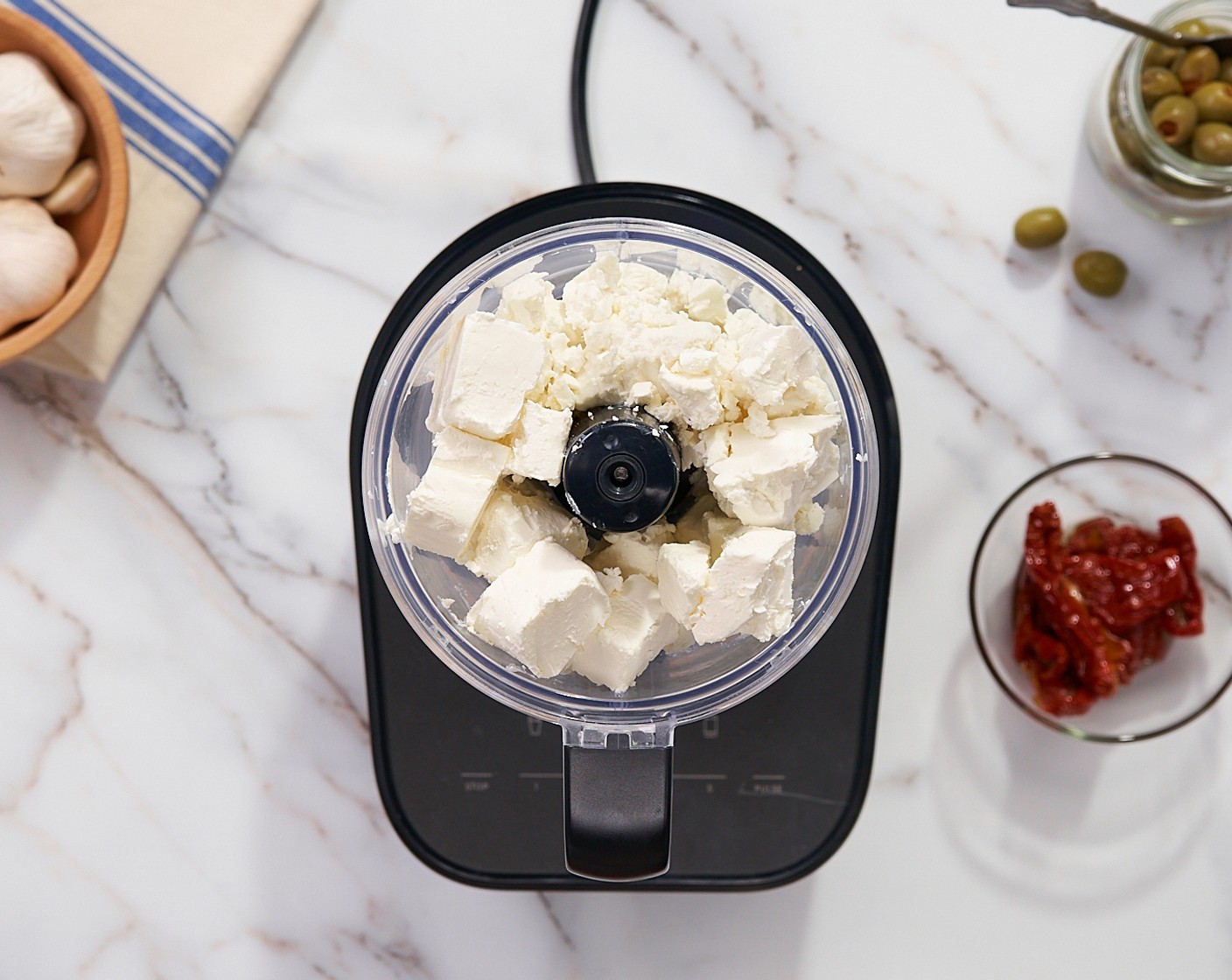 step 1 Add Feta Cheese (1 1/2 cups) and Cream Cheese (1/2 cup) to a food processor or blender. Blend until smooth and creamy.