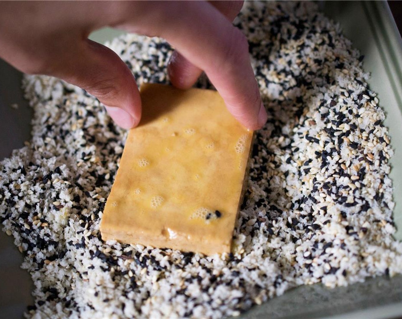 step 7 Transfer the tofu to the panko-sesame mixture, turning and pressing to coat.