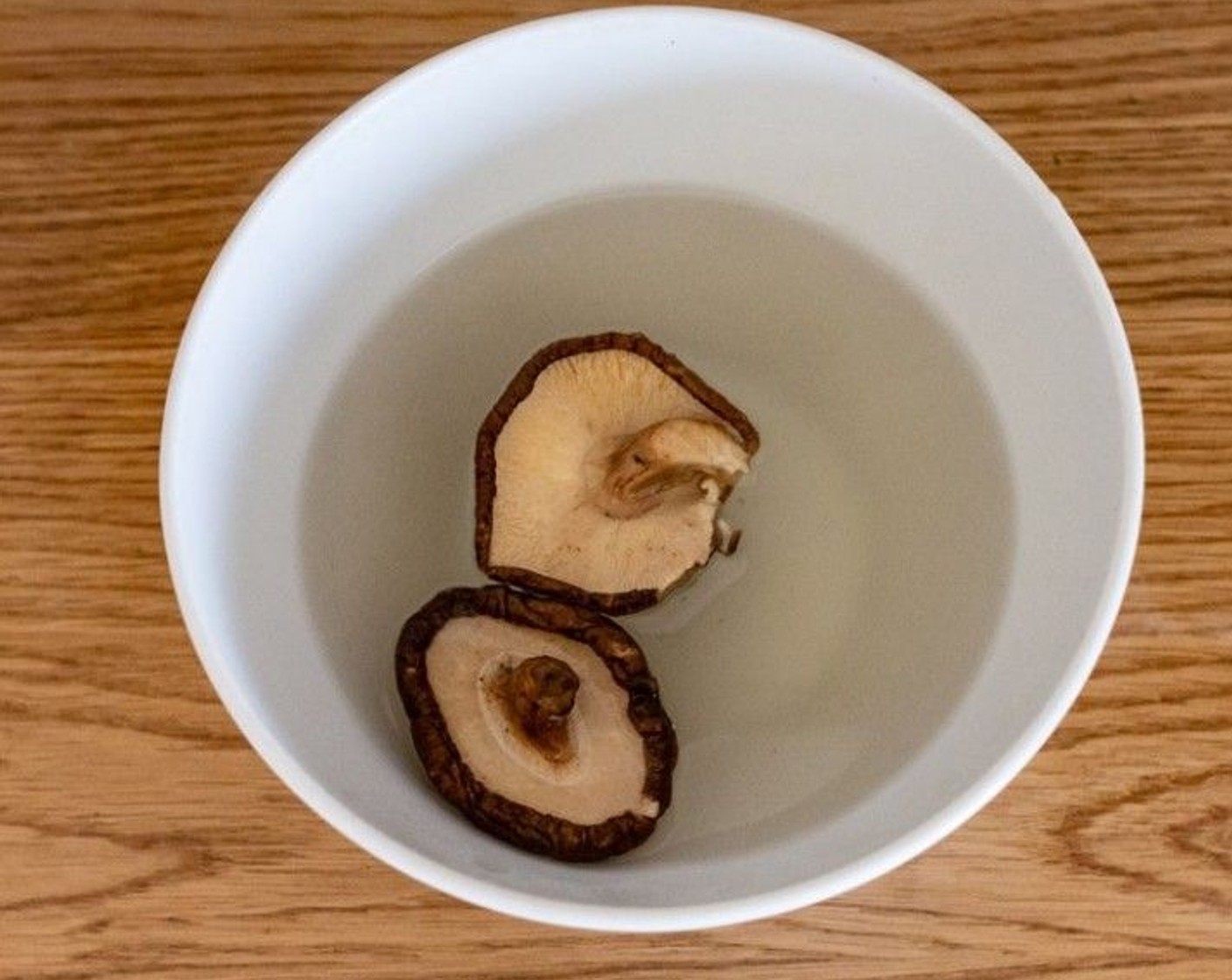 step 1 Wash the Dried Shiitake Mushrooms (2) then soak them in 250 milliliters of boiling water until they expand and turn soft.