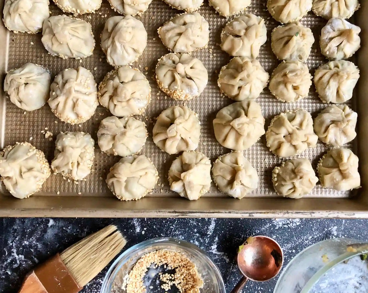 step 7 Place the Sesame Seeds (1/3 cup) in a shallow bowl. Brush the bottoms of the dumplings with water, then dredge them in the sesame seeds.