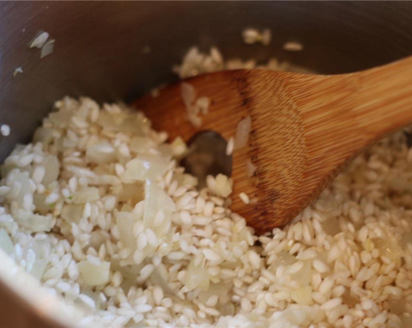 step 4 Add Arborio Rice (2 cups) and mix to coat. Sauté 2 minutes.