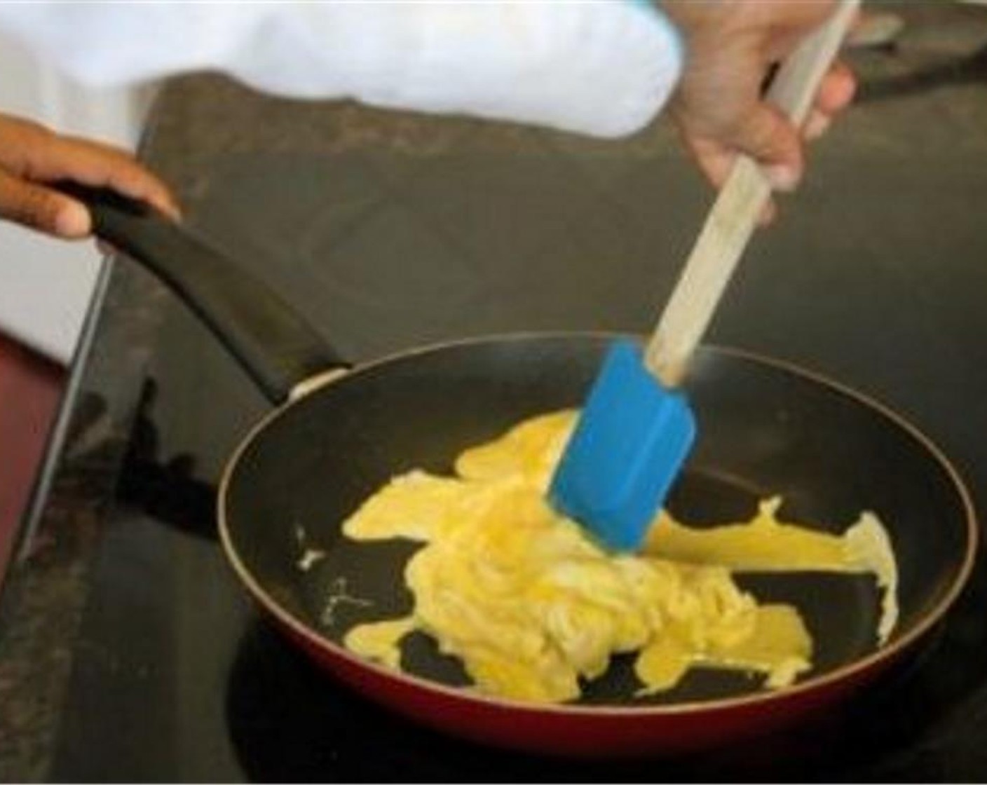 step 5 Spray a skillet with Olive Oil Cooking Spray (as needed). Pour the egg mixture in the heated pan. As the edges and bottom of the eggs get firm, push the edges towards the middle Continue to push and flip the firm parts of the eggs until no liquid parts remain. Place cooked eggs in a bowl.