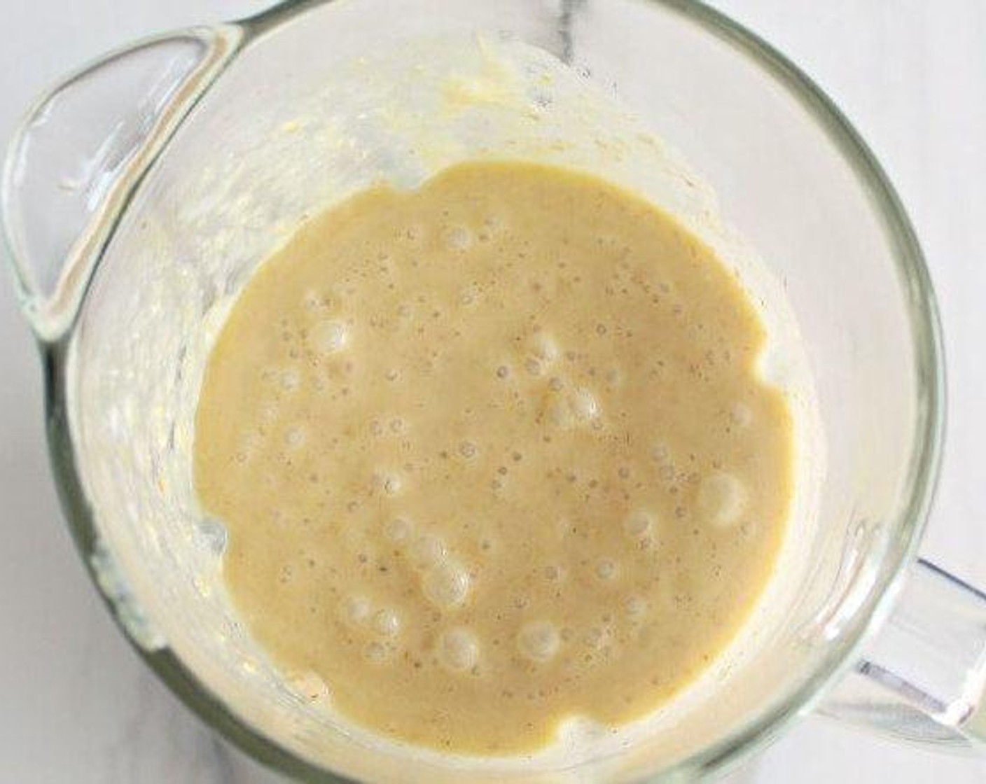 step 2 Place Old Fashioned Rolled Oats (1 cup), Bananas (2) rind and juice from Lemons (1 1/3), Farmhouse Eggs® Large Brown Eggs (2), Greek Yogurt (1 cup), Honey (3 Tbsp), Baking Powder (1 tsp), Baking Soda (1/2 tsp), Vanilla Extract (1 tsp), Salt (1 pinch) in a blender or food processor and pulse until combined, then blend continuously until the mixture is smooth and the oats are almost completely broken down.