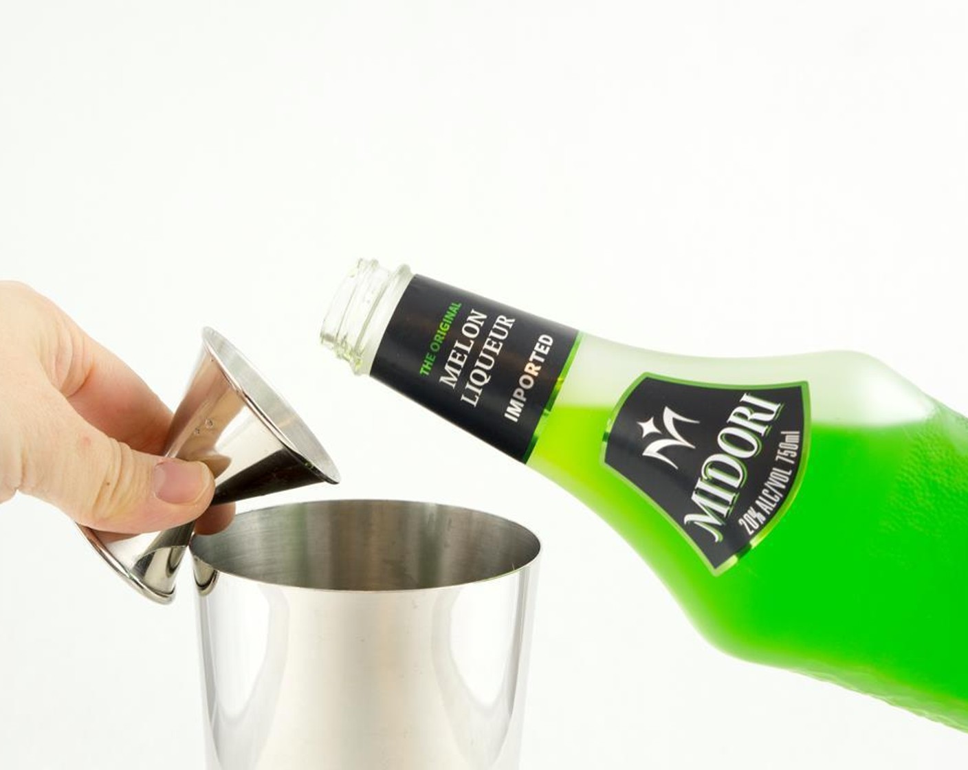 step 2 Pour Midori (1 fl oz) into the shaker.