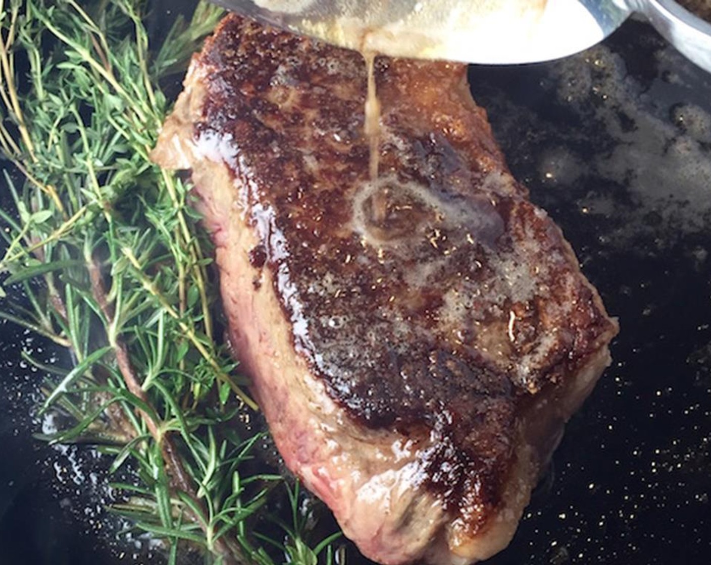 step 4 Flip the steak, and add the Fresh Rosemary (3 sprigs), Fresh Thyme (3 sprigs) and Butter (2 Tbsp). Baste the steak with melted butter.