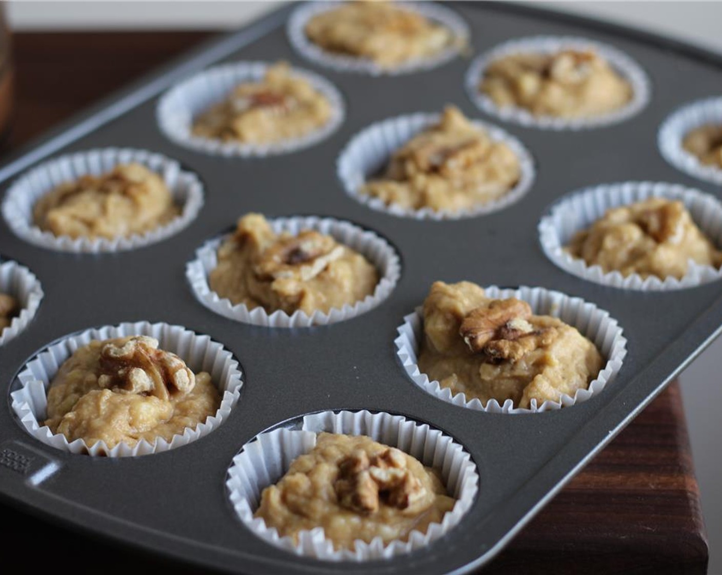 step 5 Pour into muffin tins. Top each muffin with a walnut. Bake for 20-25 minutes. Enjoy!