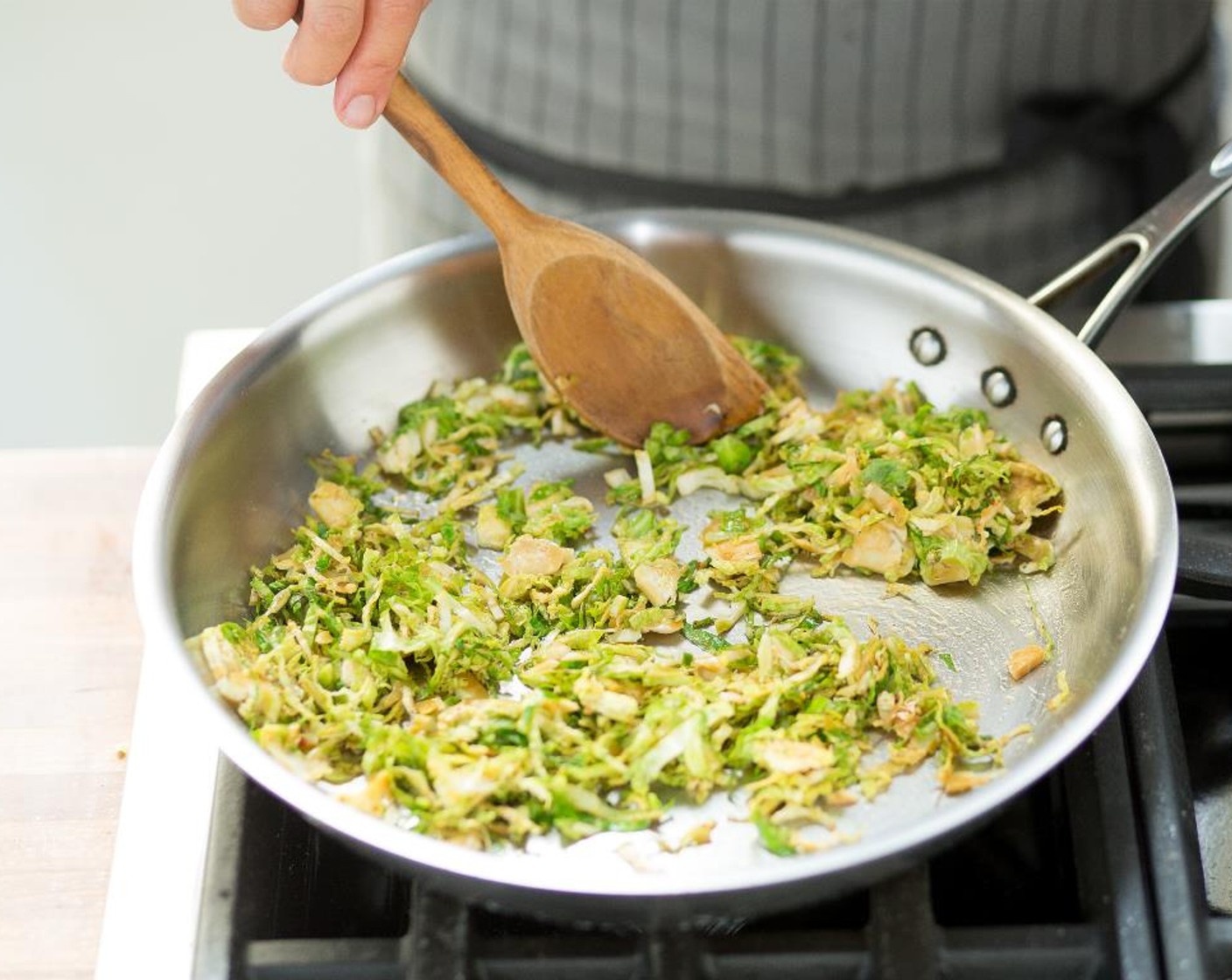 step 7 In another large sauté pan, heat Canola Oil (1 Tbsp) over medium-high heat. Add the Brussels sprouts and sauté until lightly browned, about 2 minutes. Add the tamari mixture and toss.