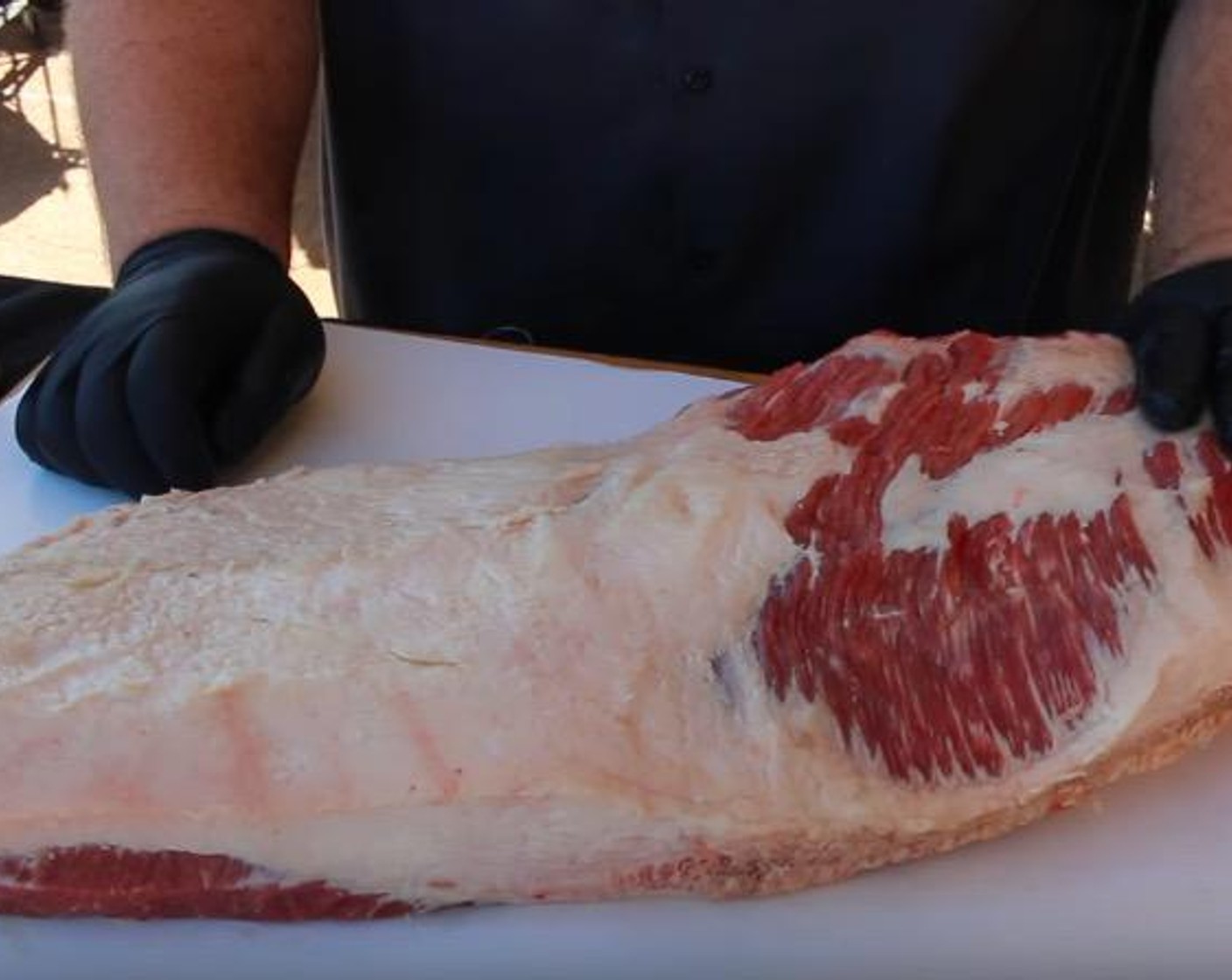 step 2 Remove Whole Beef Brisket (15 lb) from packaging, remove silver skin from meat side and trim fat to 1/4-inch so the brisket lays flat on cutting surface.