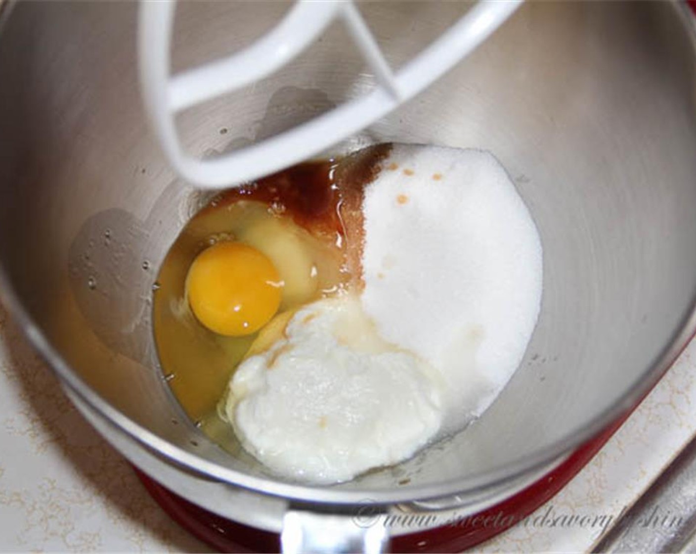 step 3 In a large mixing bowl with paddle attachment, beat the Egg (1), Granulated Sugar (2/3 cup), Greek Yogurt (1/3 cup), Vanilla Extract (1 Tbsp) and Almond Extract (1/4 tsp) together until well combined.