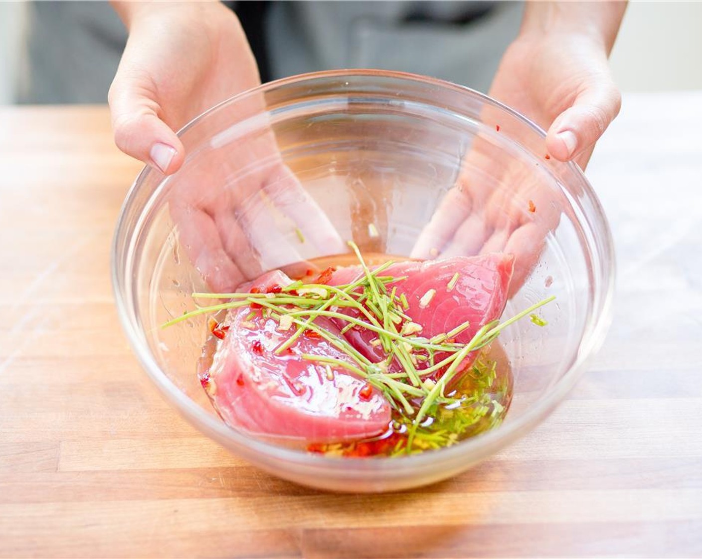 step 5 Whisk the lime zest, chopped fresno chile  and cilantro stems into the large bowl with the marinade. Pat dry Ahi Tuna Steak (2) with paper towels and place the tuna into the large bowl with the marinade. Coat the ahi and let marinate.