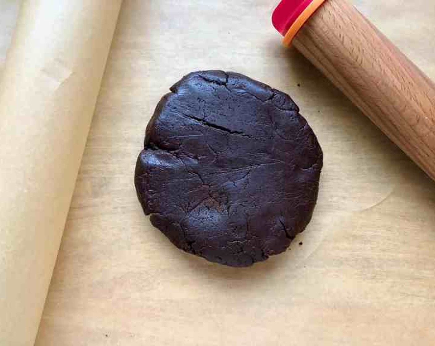 step 6 Working with one disk at a time, roll out the dough between 2 sheets of parchment paper until 1/8-inch thick. Slide onto baking sheets, still sandwiched between parchment, and chill until very firm, about 1 hour.