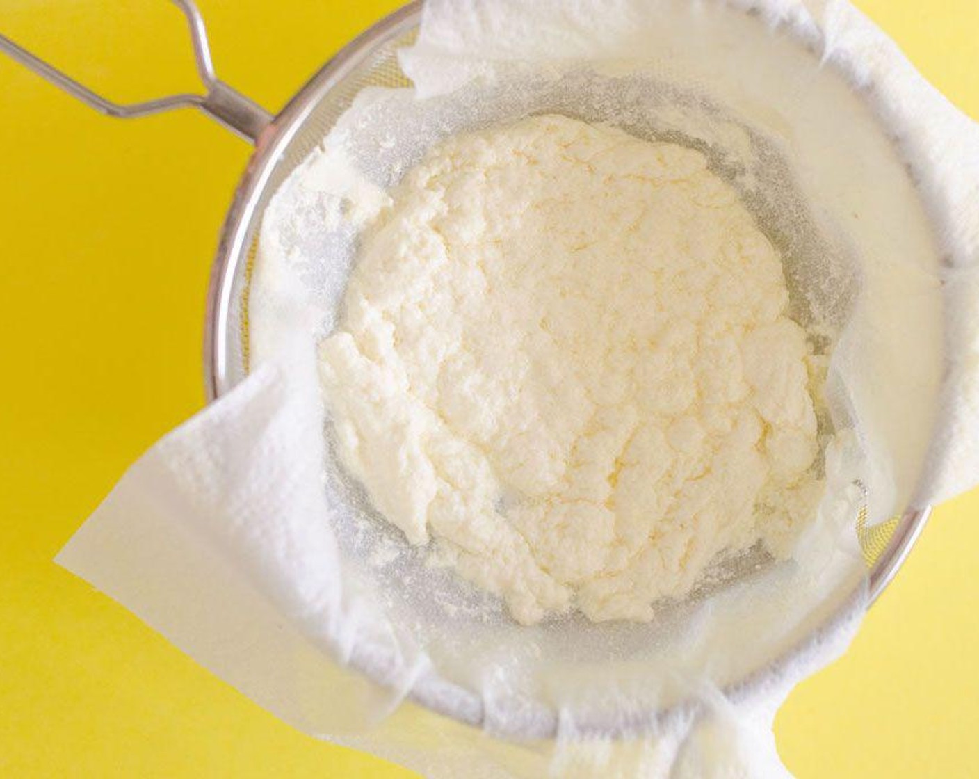 step 2 Set two layers of paper towels in a wire mesh sieve, and set over a large bowl. Gently pour the milk mixture into the sieve to strain out the liquid. You can let your ricotta strain up to 1 hour. The longer it sits, the firmer your ricotta will be, though I like it fresh and warm.