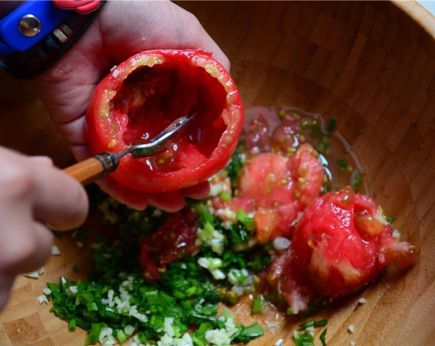 step 3 Remove the Tomatoes (4) core, and scoop the pulp into a medium-sized bowl. Add chives, basil, and Olive Oil (as needed) to the tomato pulp.