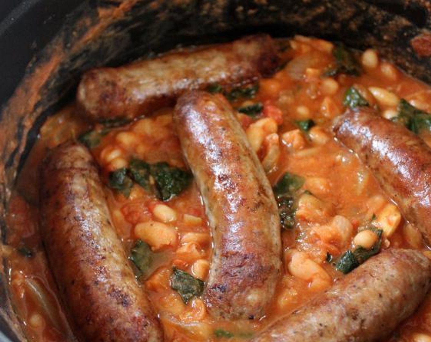 step 7 Add Kosher Salt (1/4 tsp) and Ground Black Pepper (1/4 tsp), stir to combine, and then place the cooked sausages on top of the beans. Simmer for 3 more minutes, until the sausages are warmed through.