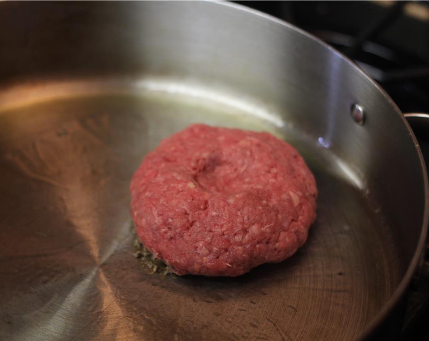 step 9 Add grapeseed oil (1 Tbsp) to a pan oven medium high heat. Season the side of the patty without the indent with baby's spice and place that side down on the hot pan.