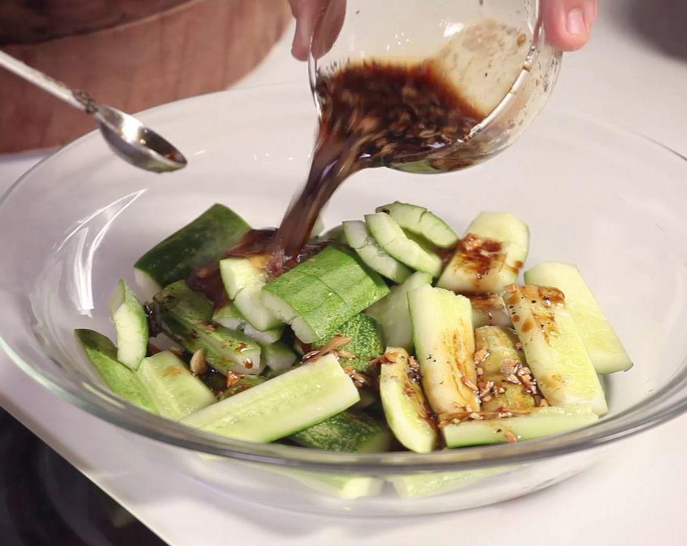 step 5 Pour the sauce over the smashed cucumber. Serve immediately.