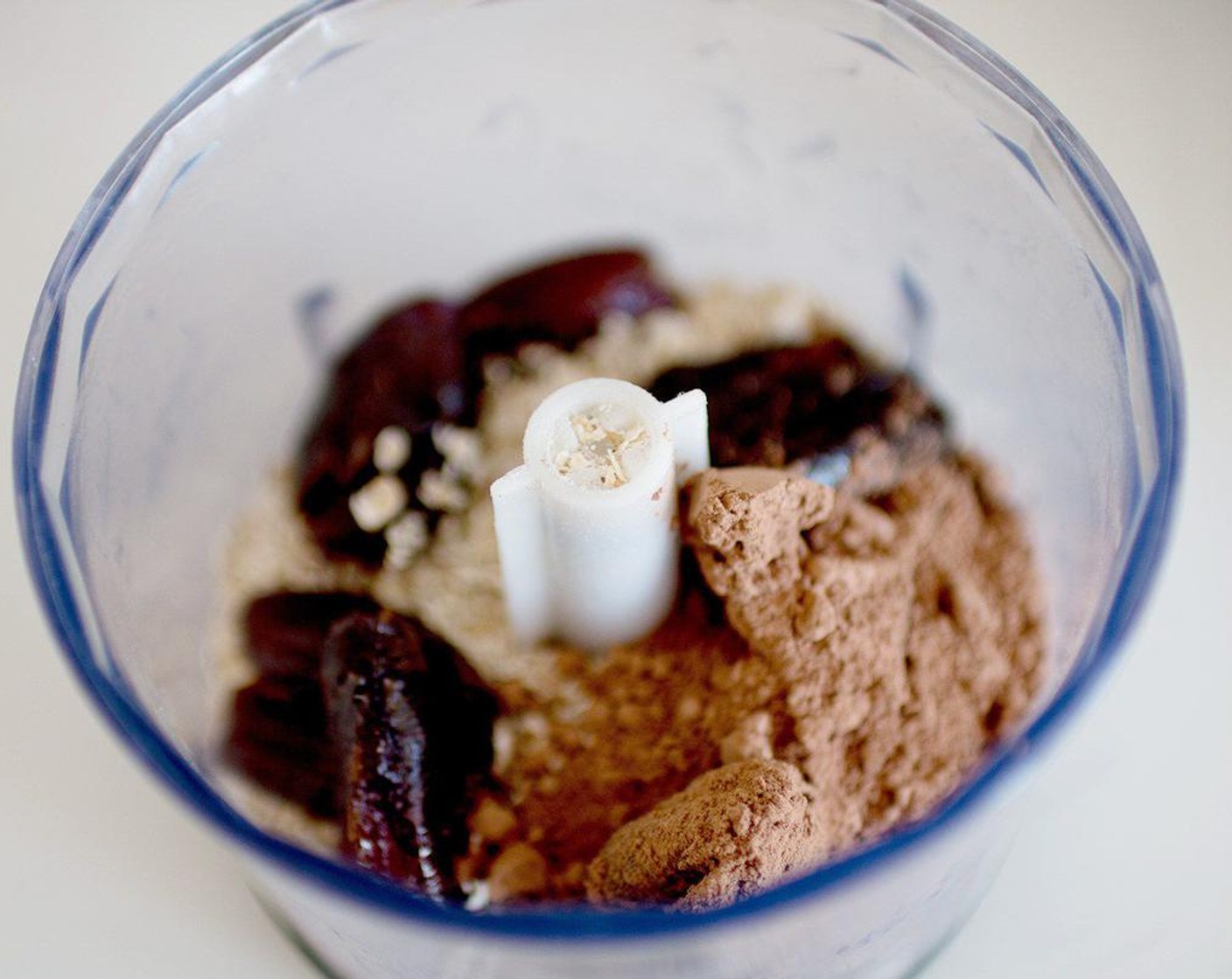 step 1 Place Medjool Dates (1/2 cup), Old Fashioned Rolled Oats (1 cup), Coconut Oil (1 Tbsp), and Raw Cacao Powder (1 Tbsp) a food processor and blend until you get a fine meal.