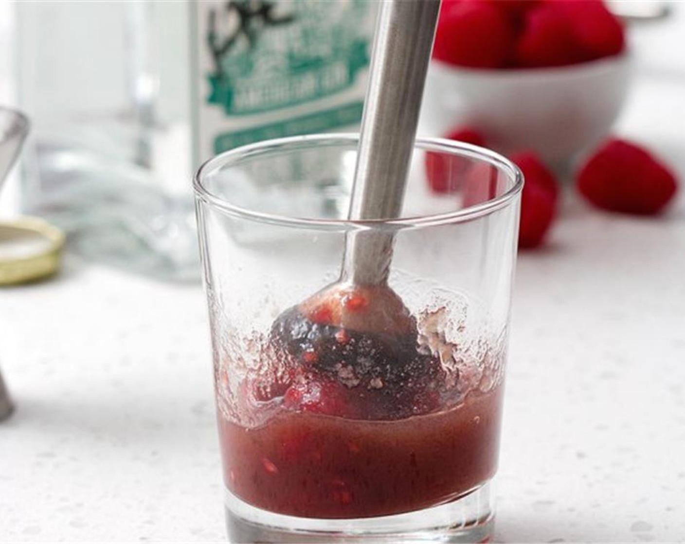 step 1 Muddle the Just Jan’s® Seedless Raspberry Spread (2 Tbsp), a few Fresh Raspberries (to taste), and FEW® American Gin (1.5 fl oz) in a glass.