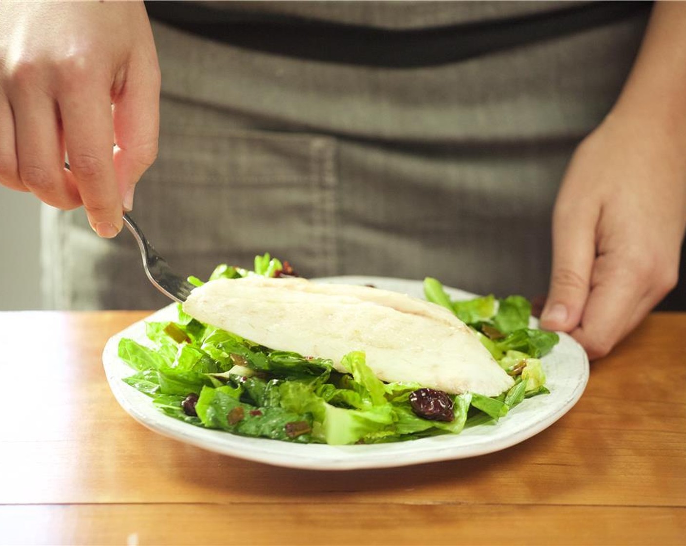 step 9 In the center of two plates, evenly distribute the salad. Place the red snapper over the salad and squeeze the remaining lemon over the fillets.