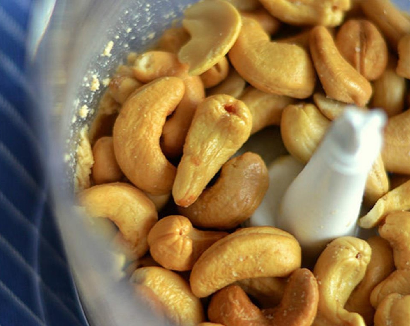 step 2 Add the roasted cashews into the food processor and pulse.