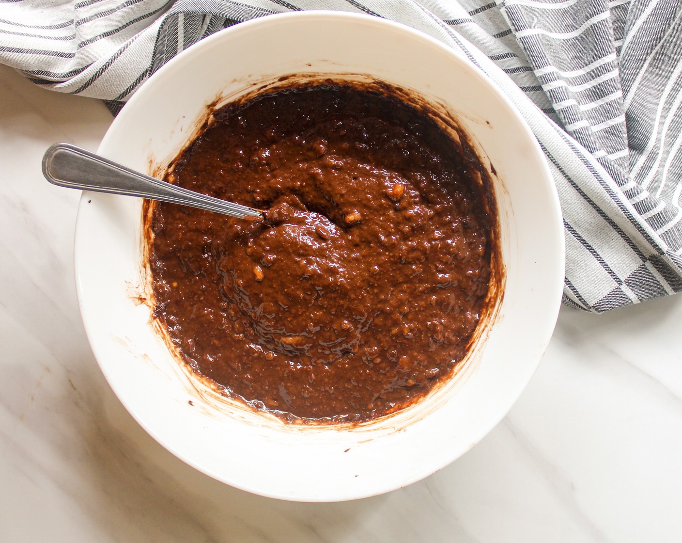 step 3 Add in the Peanut Butter (1/2 cup) and Unsweetened Cocoa Powder (1/4 cup) into the mashed bananas. Combine till well mixed.