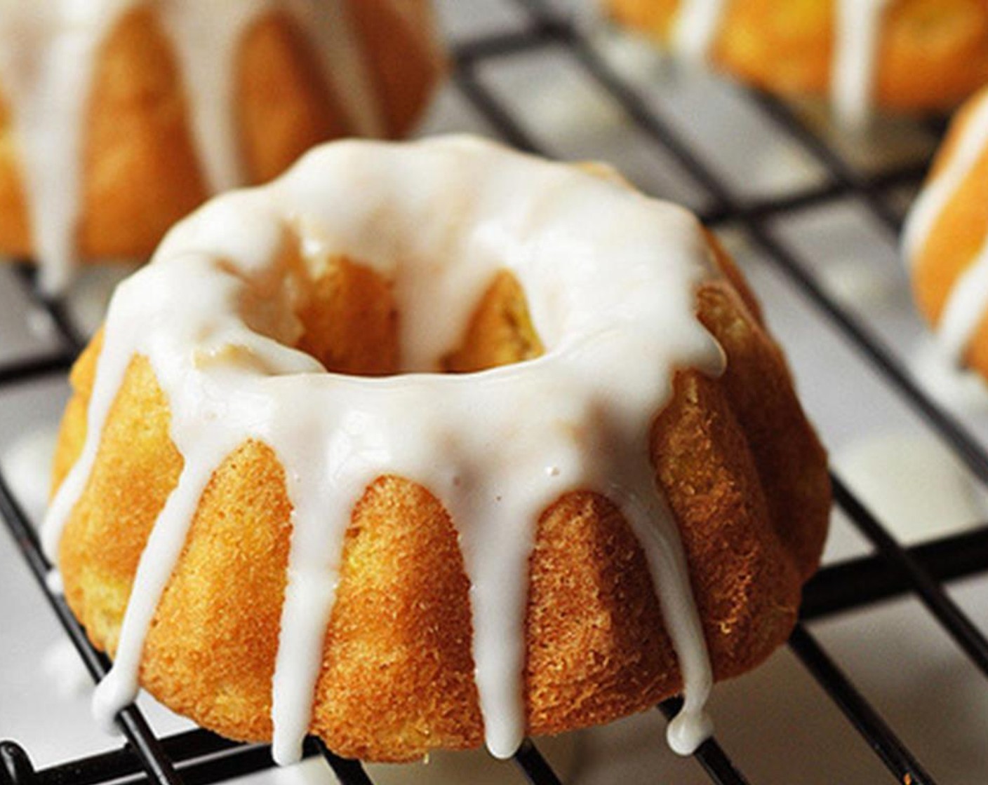 step 15 Spoon the glaze over each bundt cake, allowing it to drip down onto the sides.