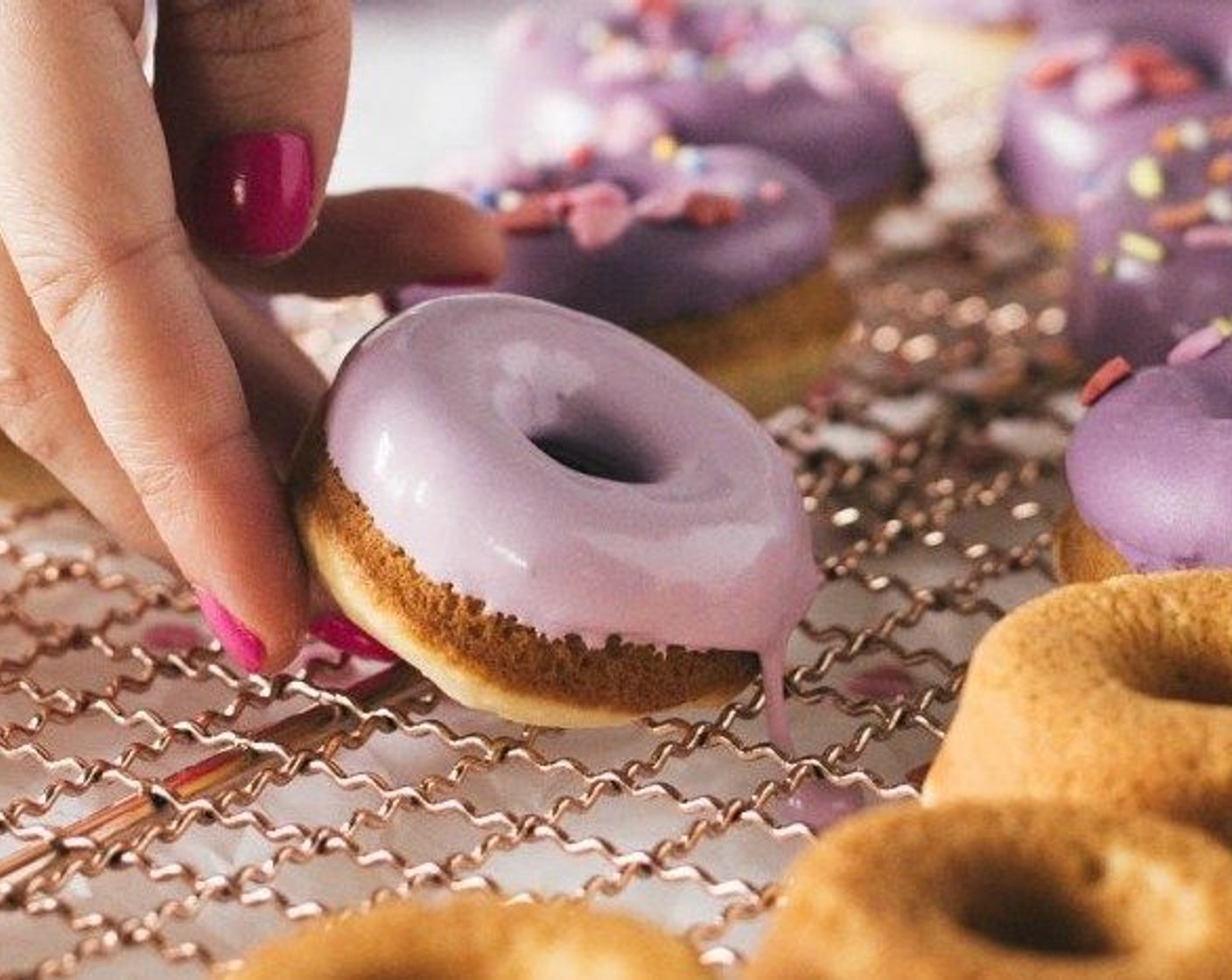 step 7 Dip the donuts into the frosting and place sprinkles on immediately. Mix the frosting in between each donut. You will need to re-heat the frosting as needed every few minutes.