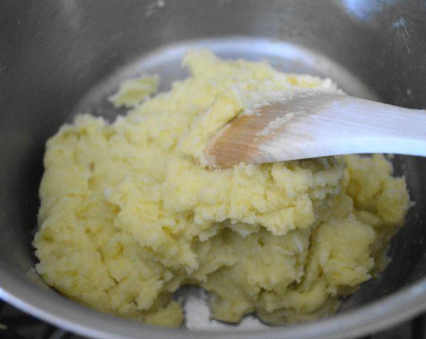 step 4 Lightly mash the garlic cloves into the potatoes, they should just melt right in. Then give it all a big stir until the potatoes are fluffy and creamy. Taste for salt and add another pinch or two until it is to your taste.