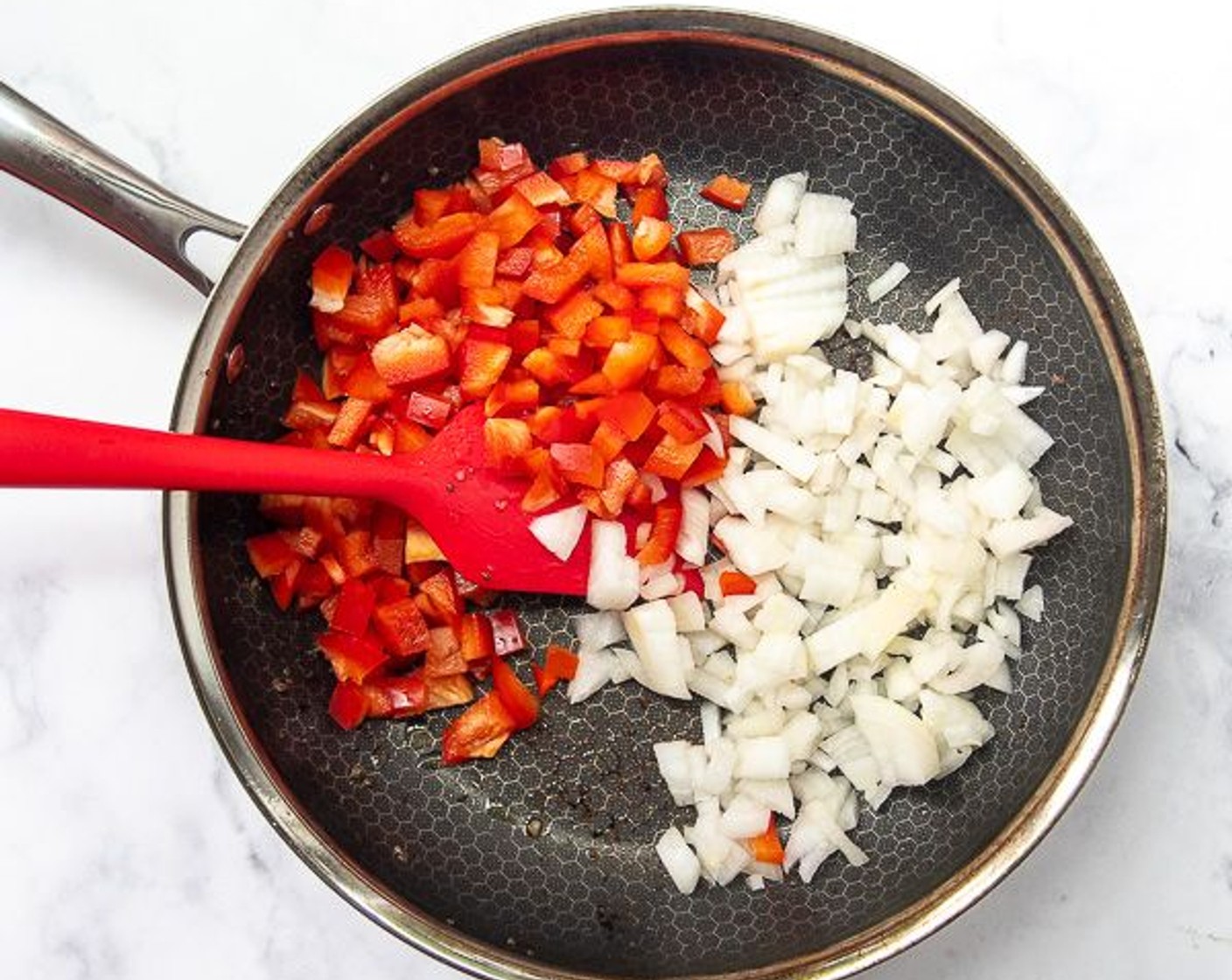 step 5 In the same skillet saute Onion (1) and Red Bell Pepper (1) for 5 minutes, or until softened. Remove for heat and set aside.