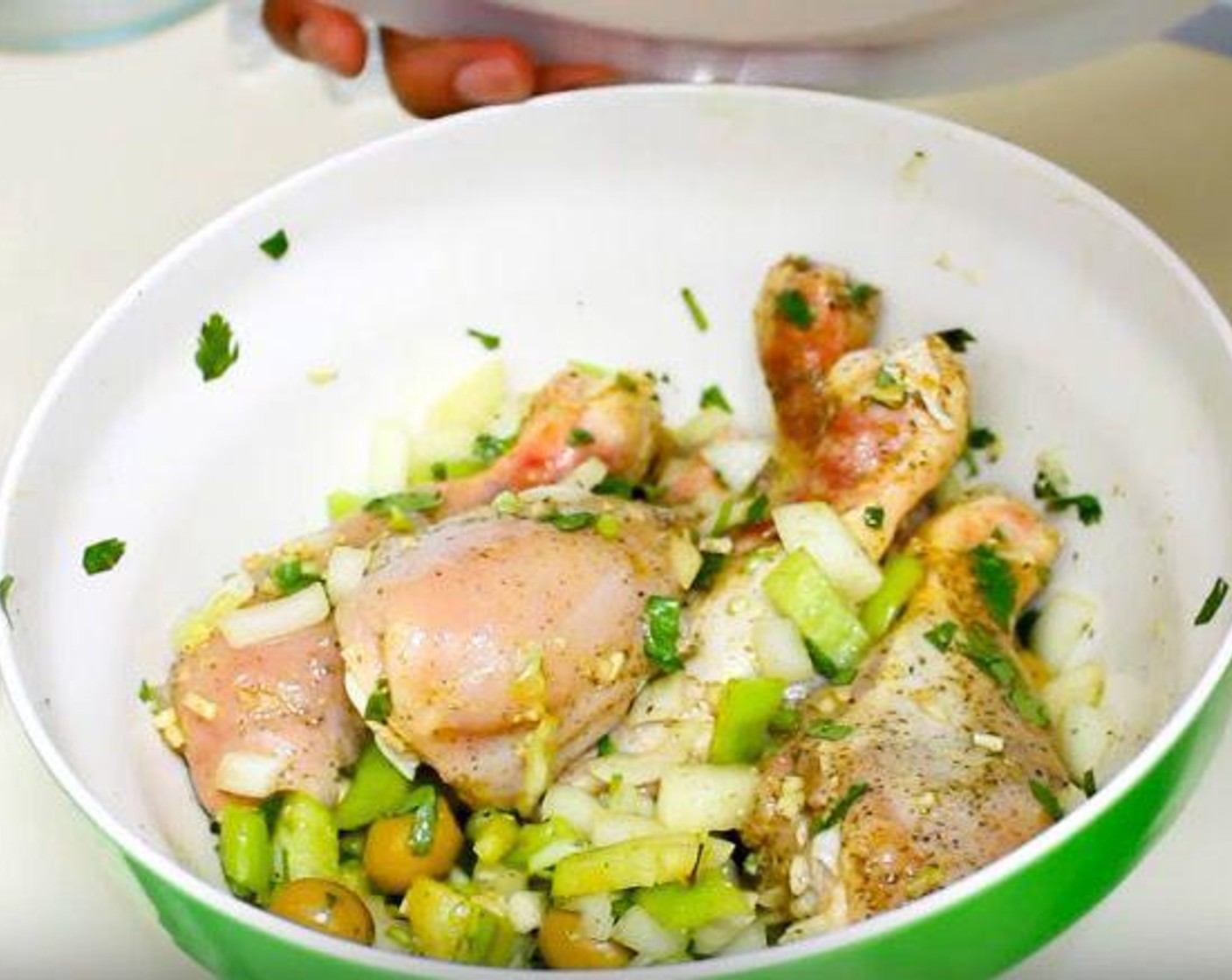 step 1 In a mixing bowl, squeeze the Lime (1) over the Chicken Drumsticks (5). Add Dried Oregano (1/2 tsp), Ground Black Pepper (1/8 tsp), Fresh Cilantro (2 1/2 Tbsp), Chicken Bouillon Powder (1 pckg), Yellow Onion (1), Garlic (3 cloves), Cubanelle Pepper (1/2), and Manzanilla Olives (1/4 cup).