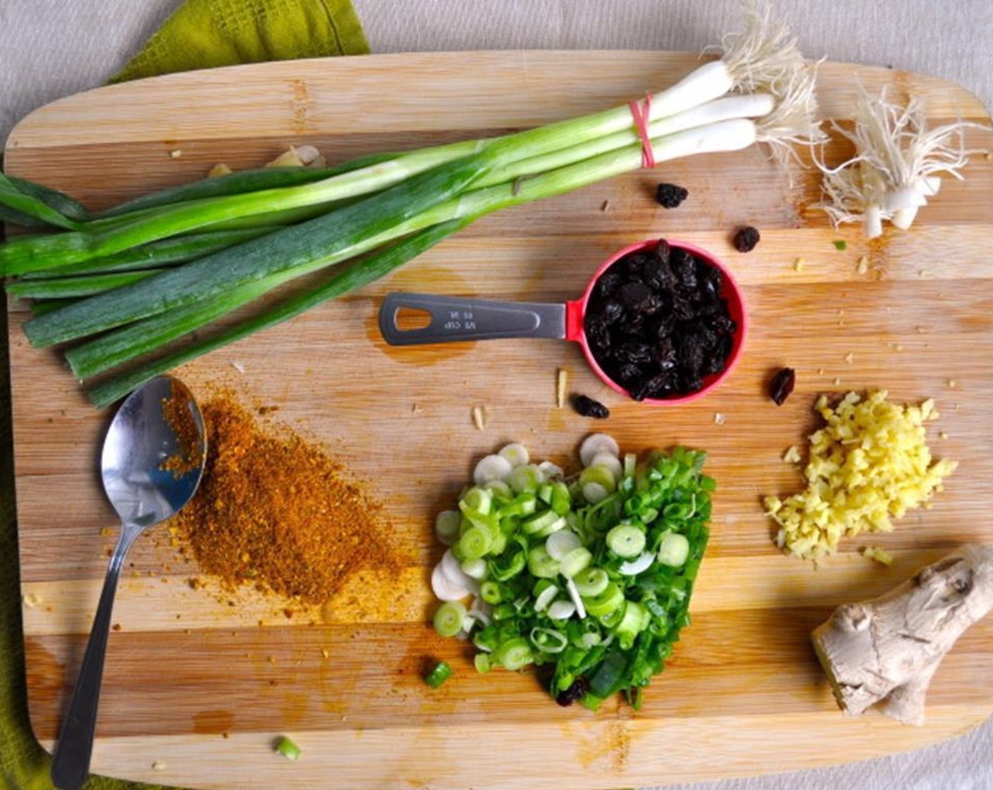 step 6 In the same pan, on medium-high heat, add Butter (2 Tbsp). Sauté Raisins (1/3 cup), remaining ginger, and half of the sliced green onions. Cook until soft, about 2 minutes.