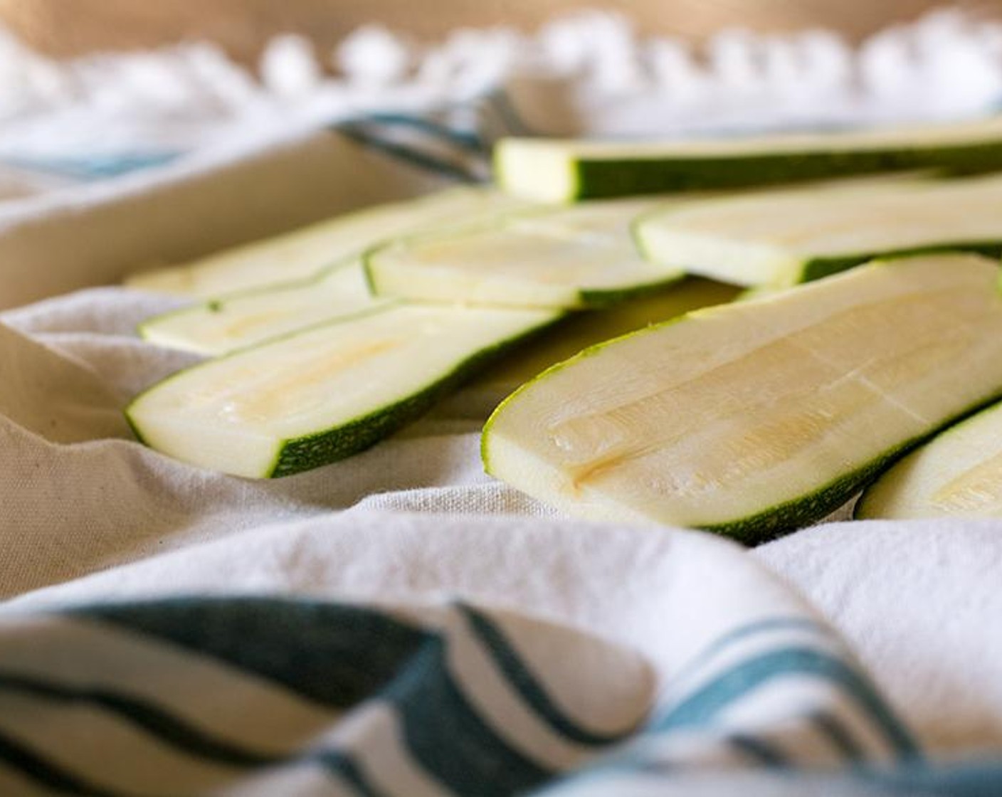 step 4 Once the zucchini has "sweat" for approximately 15 minutes, grill each slice on an indoor grill pan {stove top} or outdoor grill until soft (approx 3-4 minutes each side). Sprinkle with salt and pepper {you may want to blot the cooked zucchini with a dry paper towel to remove any extra moisture}.