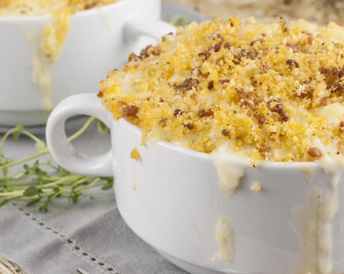 step 12 Divide equally into individual cocotte dishes or a 9x13-inch pan sprayed with nonstick spray. Top with the remaining cheese mix and then bread crumbs. Bake for 20-25 minutes until golden.