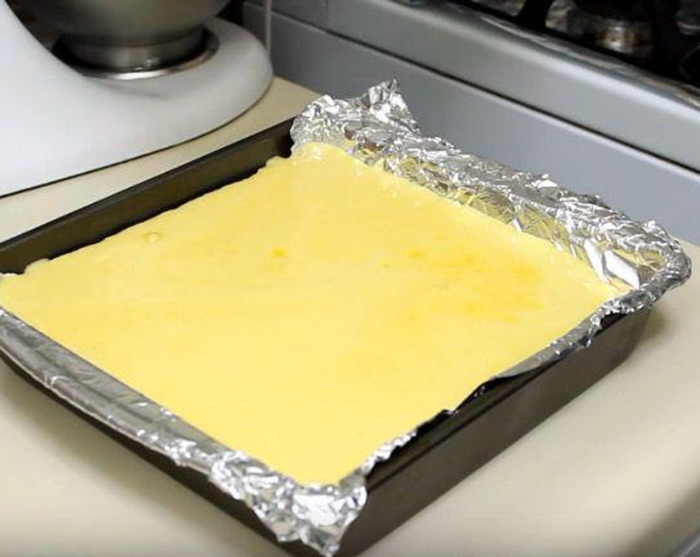 step 5 Pour lemon filling into the cooled crust. Bake for 25 minutes.