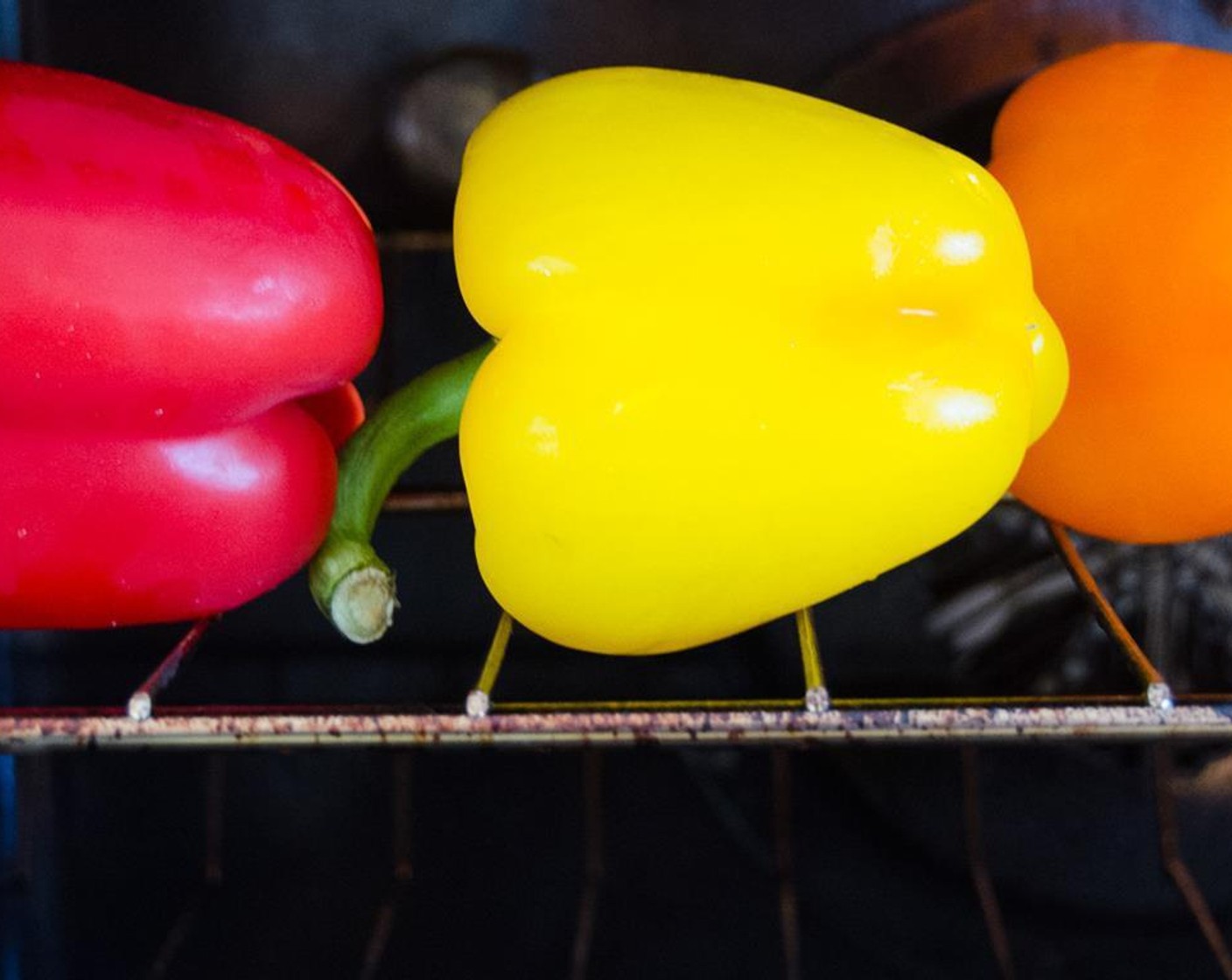 step 2 Place the Red Bell Pepper (1), Yellow Bell Pepper (1) and Orange Bell Pepper (1) into oven and cook until skin is papery and blackened, about 35 to 45 minutes.