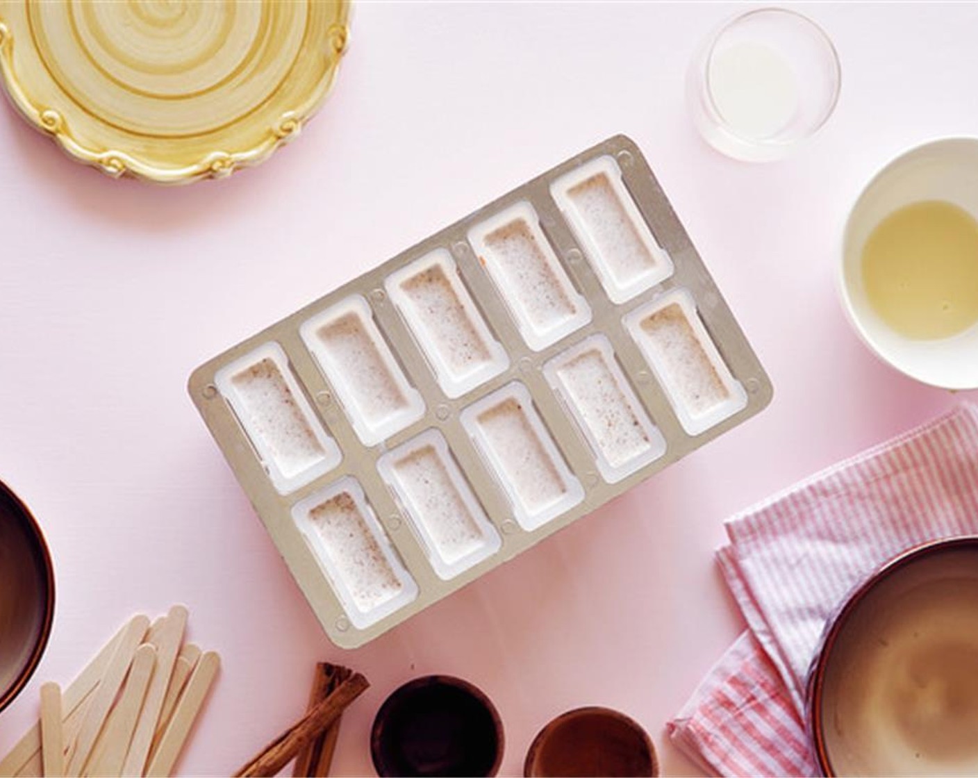 step 7 Insert wooden popsicle sticks and return the mold to the freezer and continue to freeze for another 3 to 4 hours, until they are completely frozen.