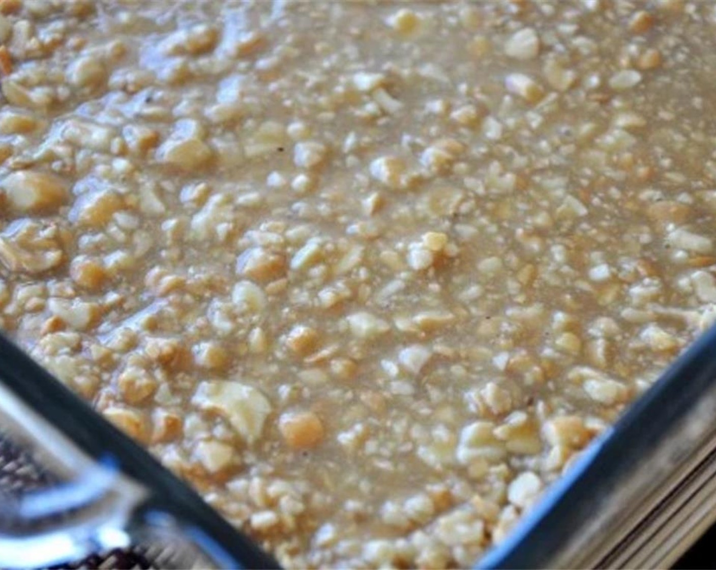 step 6 Slowly place the honey cashew topping on top of the base in the same baking dish. Use the back of a big spoon to flat it out. Bake for another 8 minutes at 350 degrees F (180 degrees C).