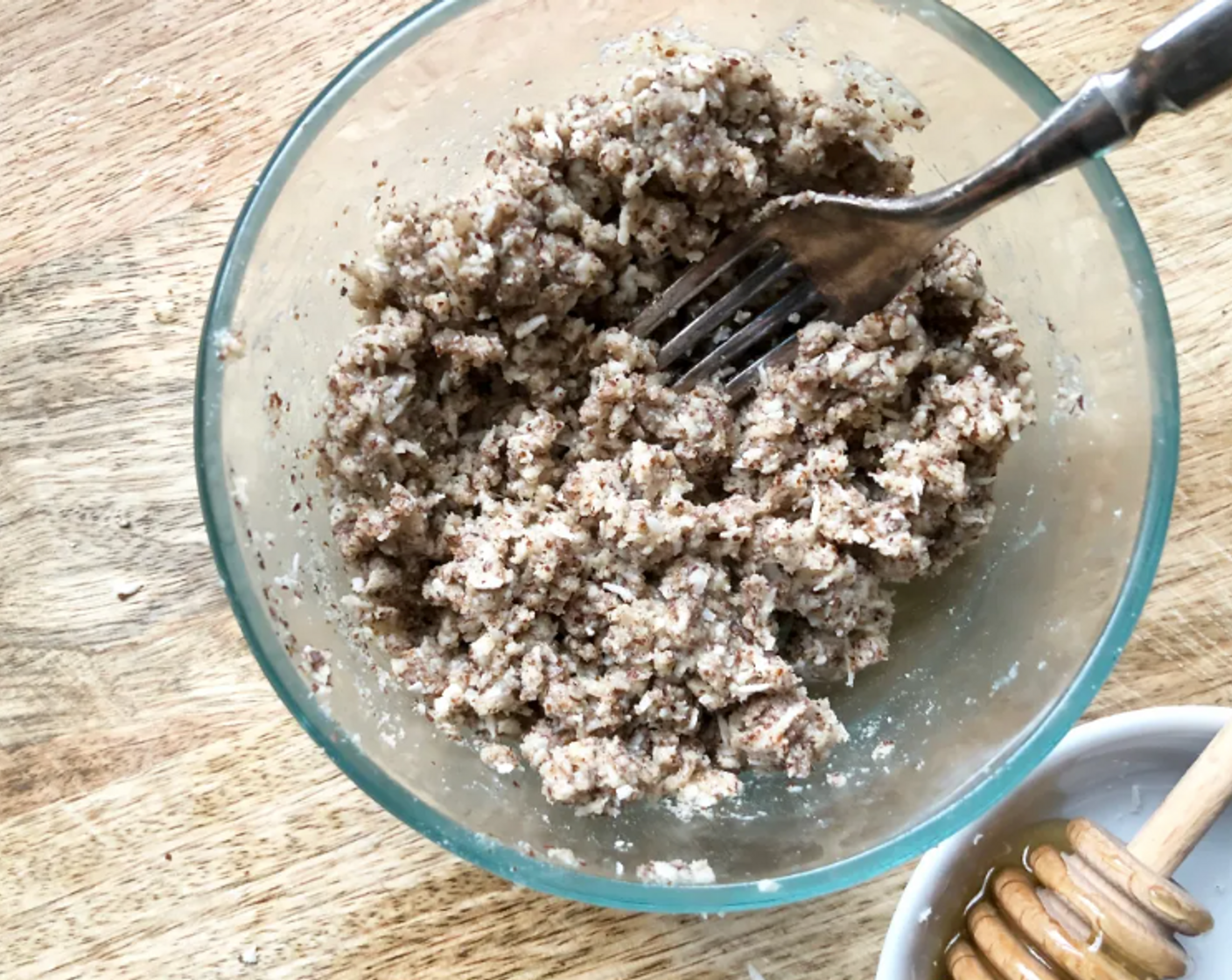 step 7 To make the crumb topping, in a bowl combine the Almond Flour (1/2 cup), Almonds (2 Tbsp) (if using), and Unsweetened Shredded Coconut (4 Tbsp). Add in the Coconut Oil (2 Tbsp), and Honey (2 Tbsp) and mix with a fork until large crumbs form.