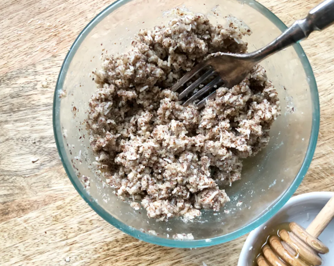 step 7 To make the crumb topping, in a bowl combine the Almond Flour (1/2 cup), Almonds (2 Tbsp) (if using), and Unsweetened Shredded Coconut (1/4 cup). Add in the Coconut Oil (2 Tbsp), and Honey (2 Tbsp) and mix with a fork until large crumbs form.