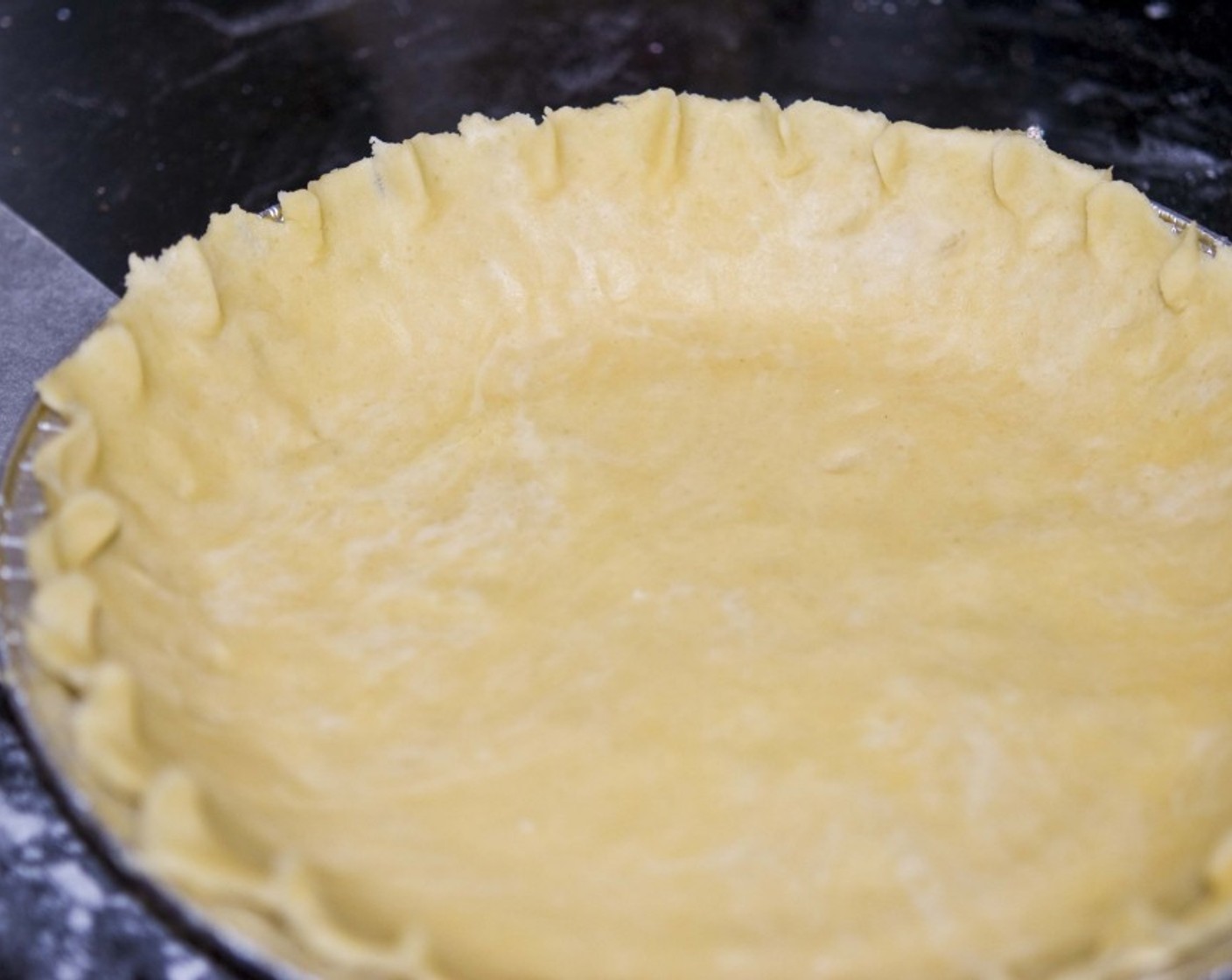 step 7 Trim off the excess dough around the edges and put the pie pan aside.