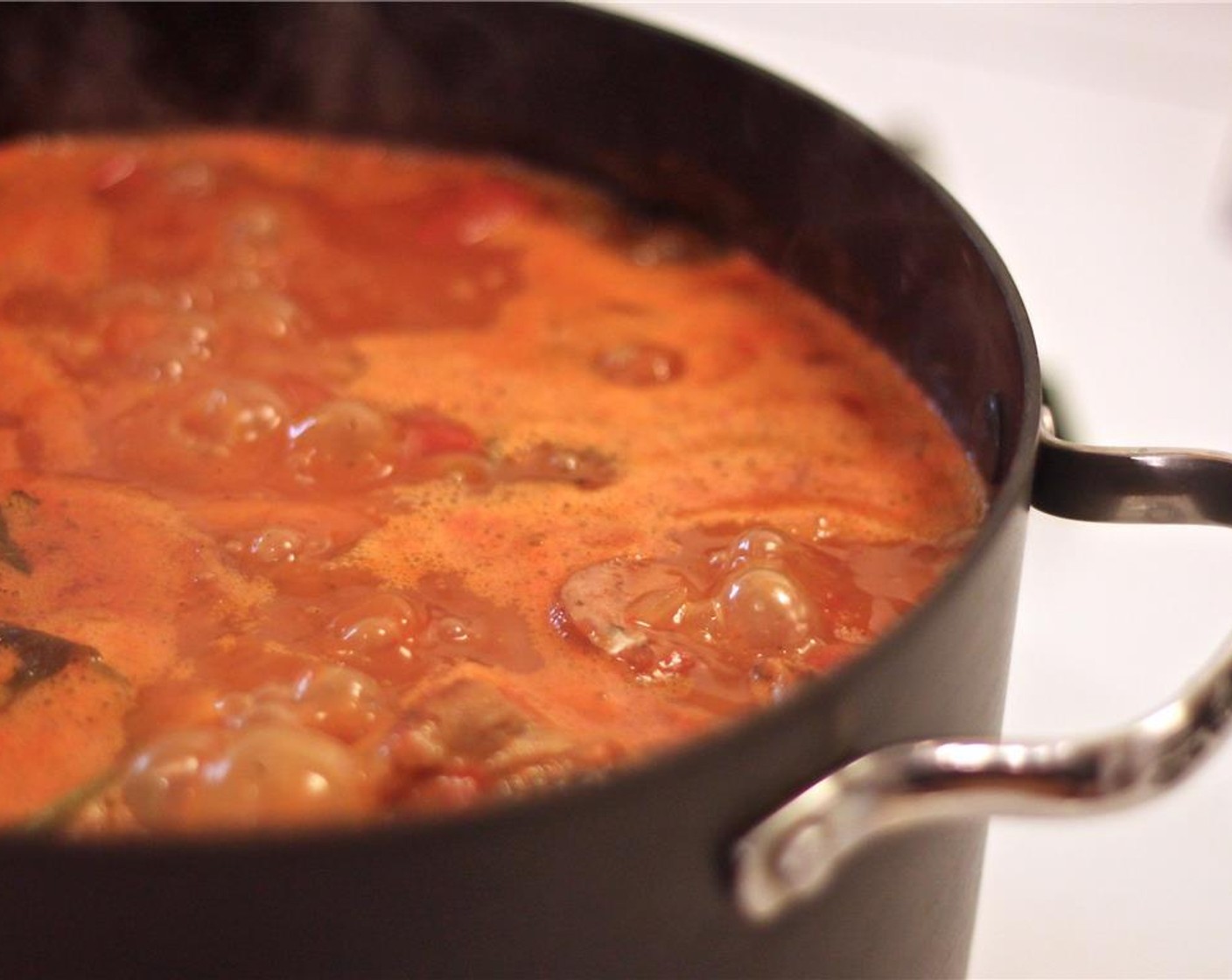 step 8 Add the Stewed Tomatoes (1 can) including the juice, crushing them in your hands.