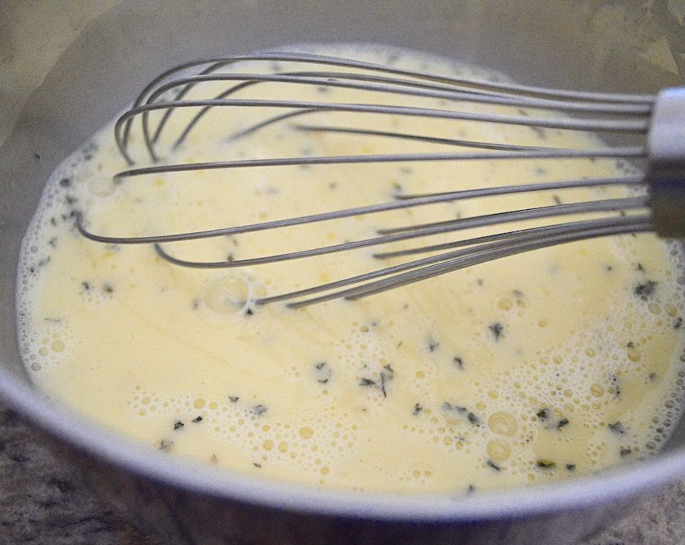 step 6 In a mixing bowl, whisk together the Eggs (6), Milk (1/2 cup), Salt (1 pinch), Ground Black Pepper (1 pinch), and Dried Parsley (1 pinch). Whisk it until you see bubbles so you know that some air is in the eggs.