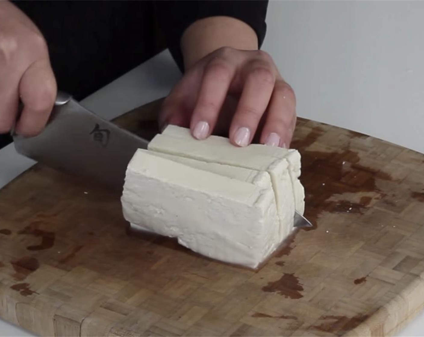 step 6 Slice Firm Tofu (8 oz) into 4 pieces. Blot slices of tofu on paper towels to absorb excess moisture.