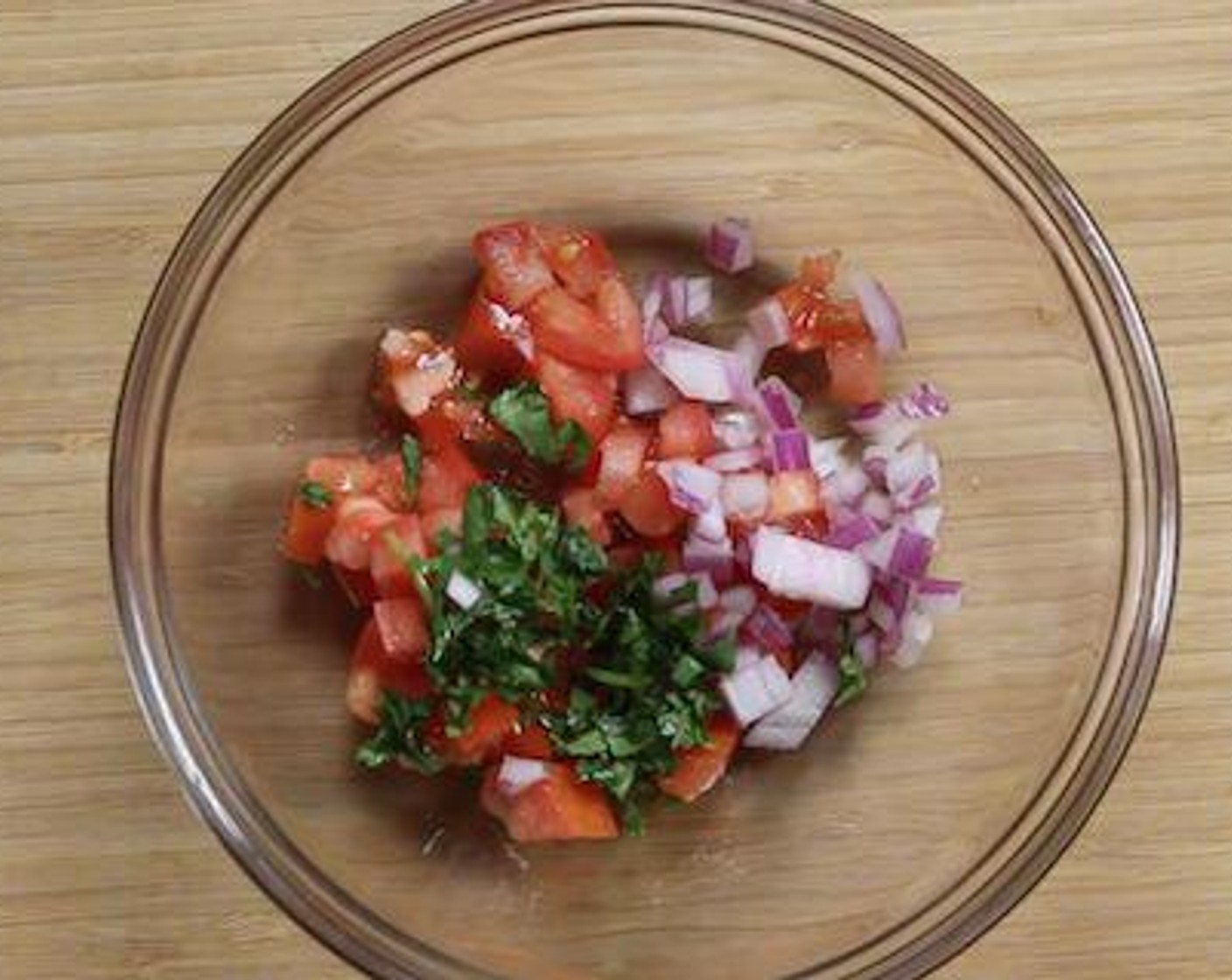 step 2 For the salsa, into a bowl add Tomato (1/4 cup), Red Onion (1 Tbsp), Fresh Parsley (1 tsp), and Lime (1/2).