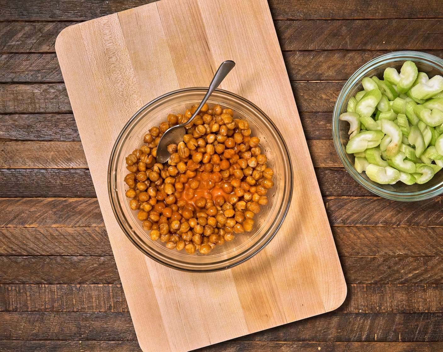 step 4 Transfer the roasted chickpeas to a large bowl. Pour in the Buffalo Sauce (1/2 cup) and stir well to combine.