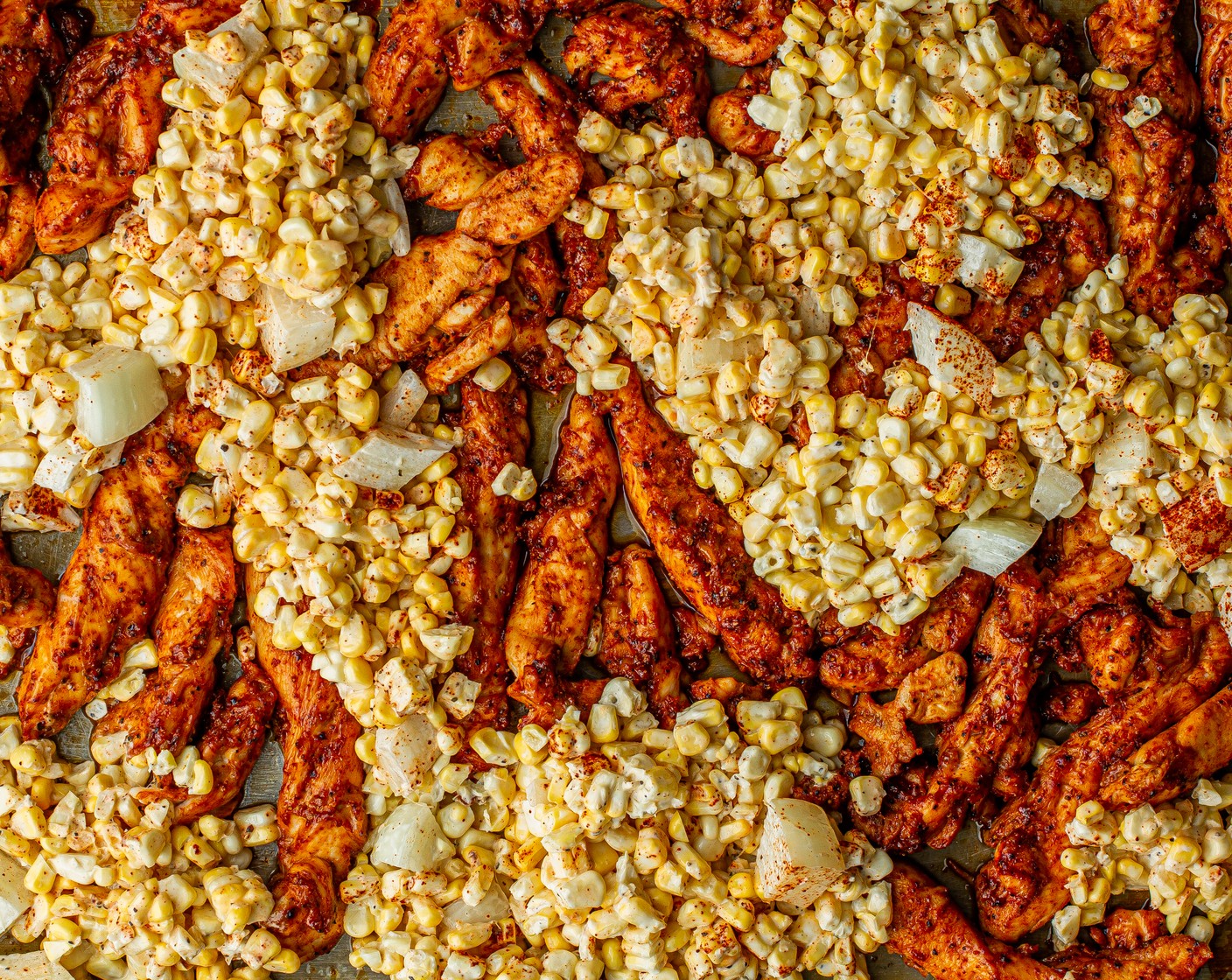 step 6 Remove the chicken from the oven. Use a spatula to make room for the corn. Add corn mixture to the sheet pan, nestling it around the chicken. Return to the oven for 10 minutes or until the chicken is thoroughly cooked and the corn is tender.