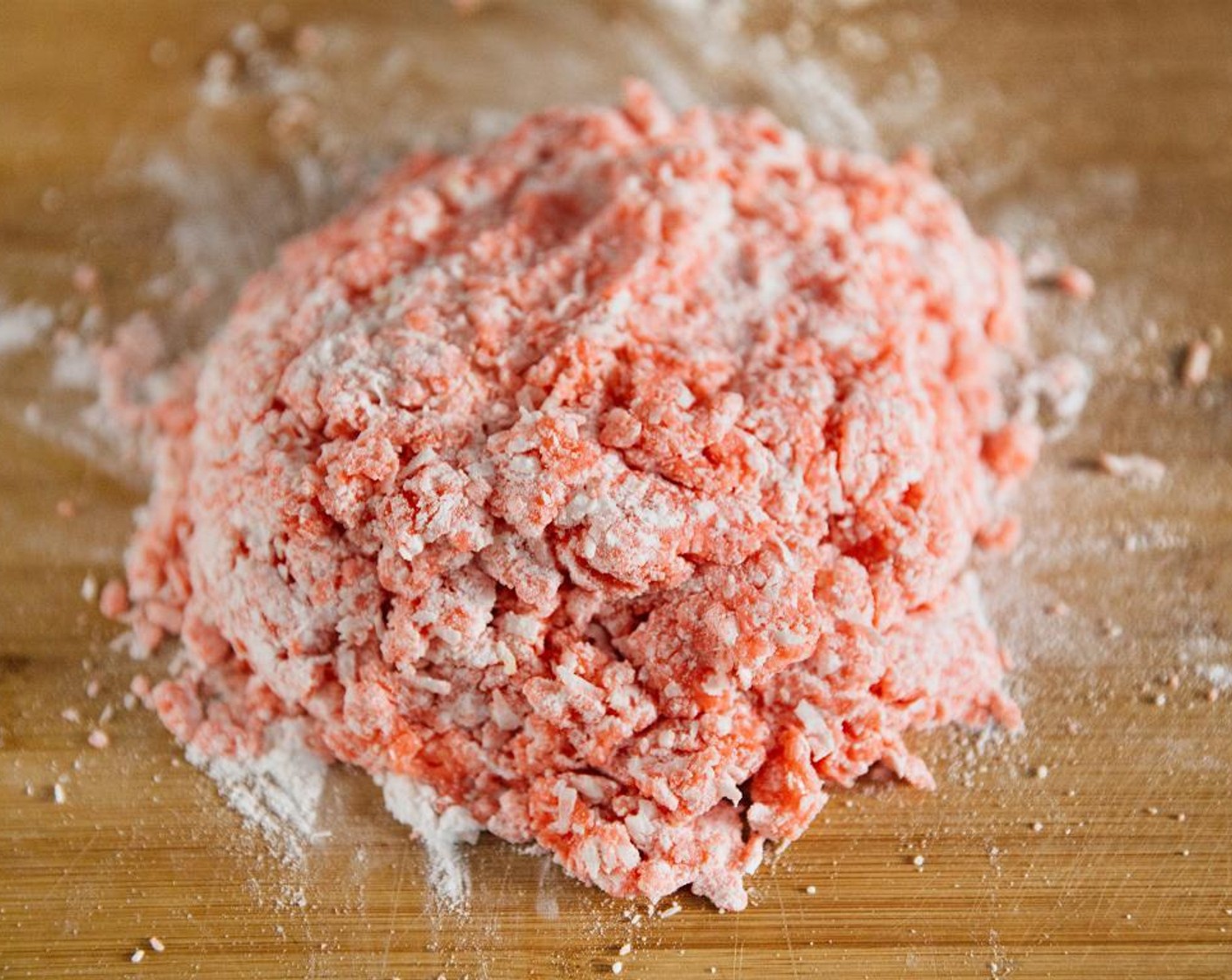 step 5 Empty the bowl on to a wooden board dusted with a little extra powdered sugar.